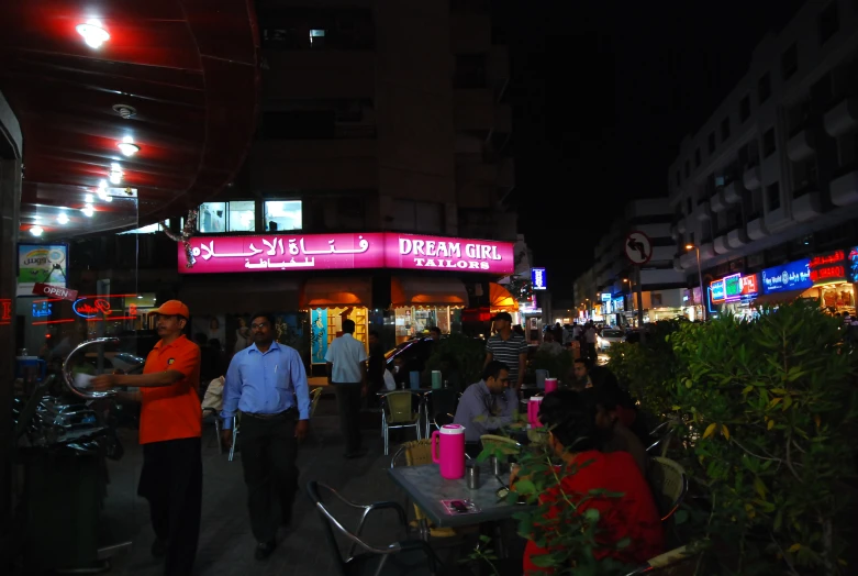 people are standing outside of an asian restaurant