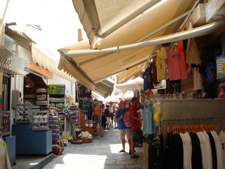 a large market with rows of stalls and umbrellas over them