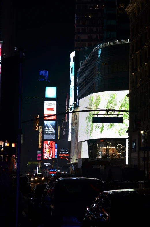 city street with traffic and skyscrs at night