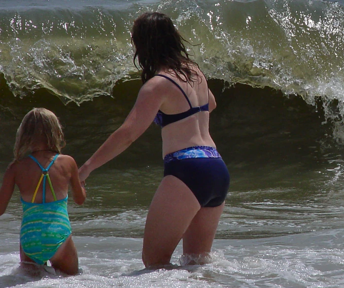 a couple of women that are standing in the water