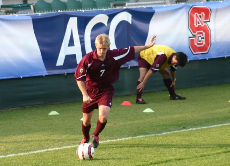 a group of men play soccer on a field