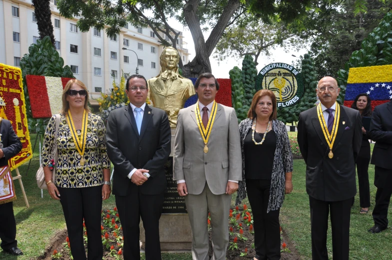 the group of people have medal badges on their neck