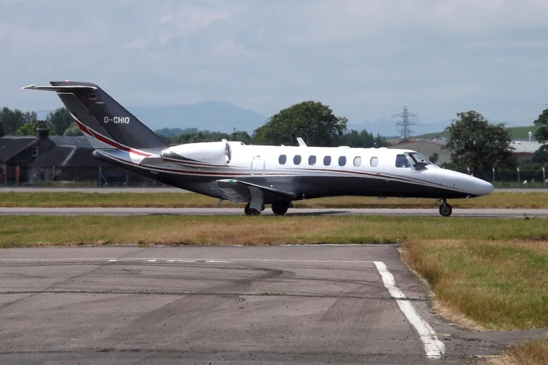 a white airplane parked on the tarmac in a field