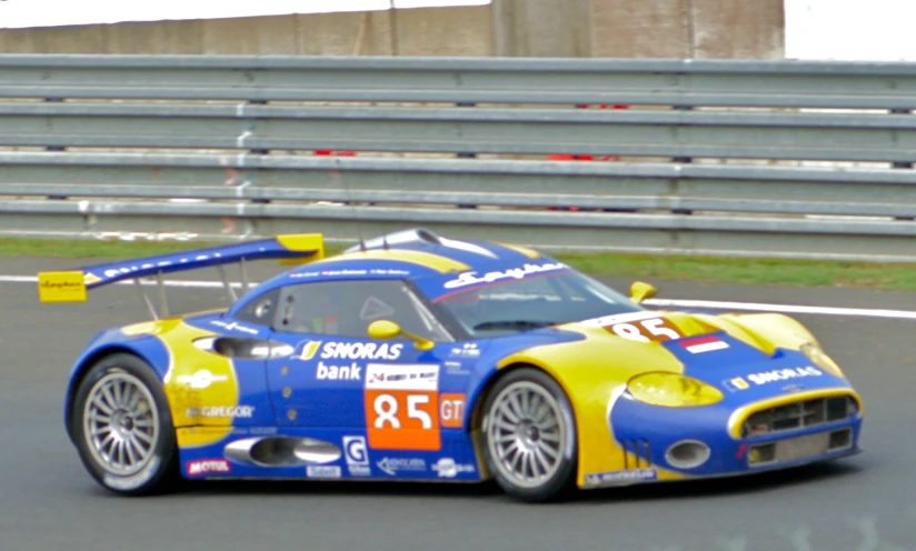 a yellow and blue car driving around a track