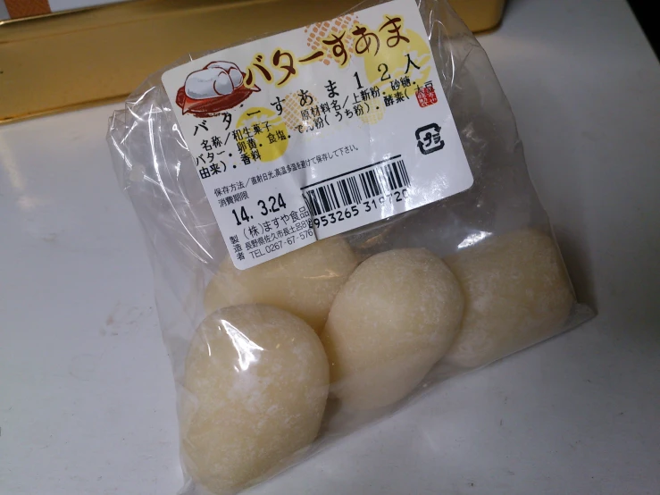 several white doughnuts are in plastic packaging