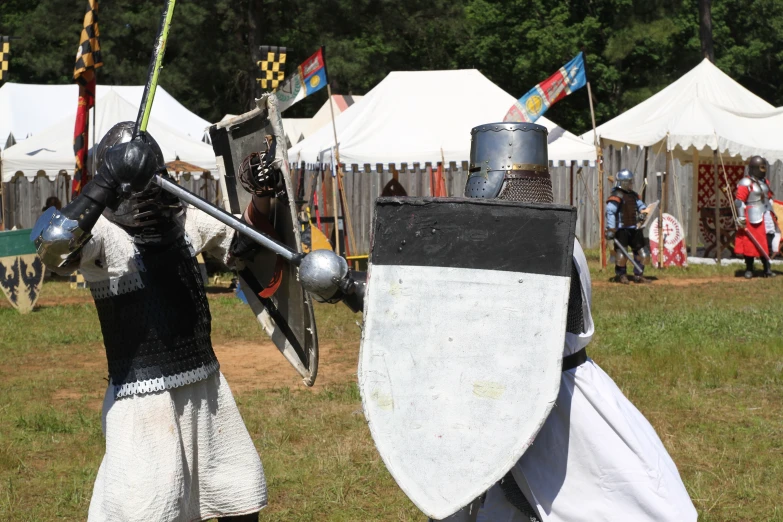 the men in costume have a sword and armor