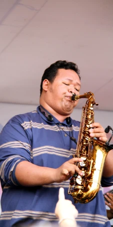 a man playing a saxophone on stage
