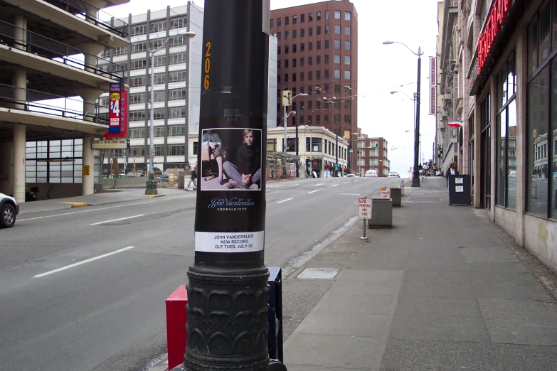 a street with a post covered in posters