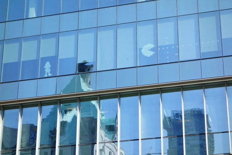 building reflection in a glass frontage with a clock tower