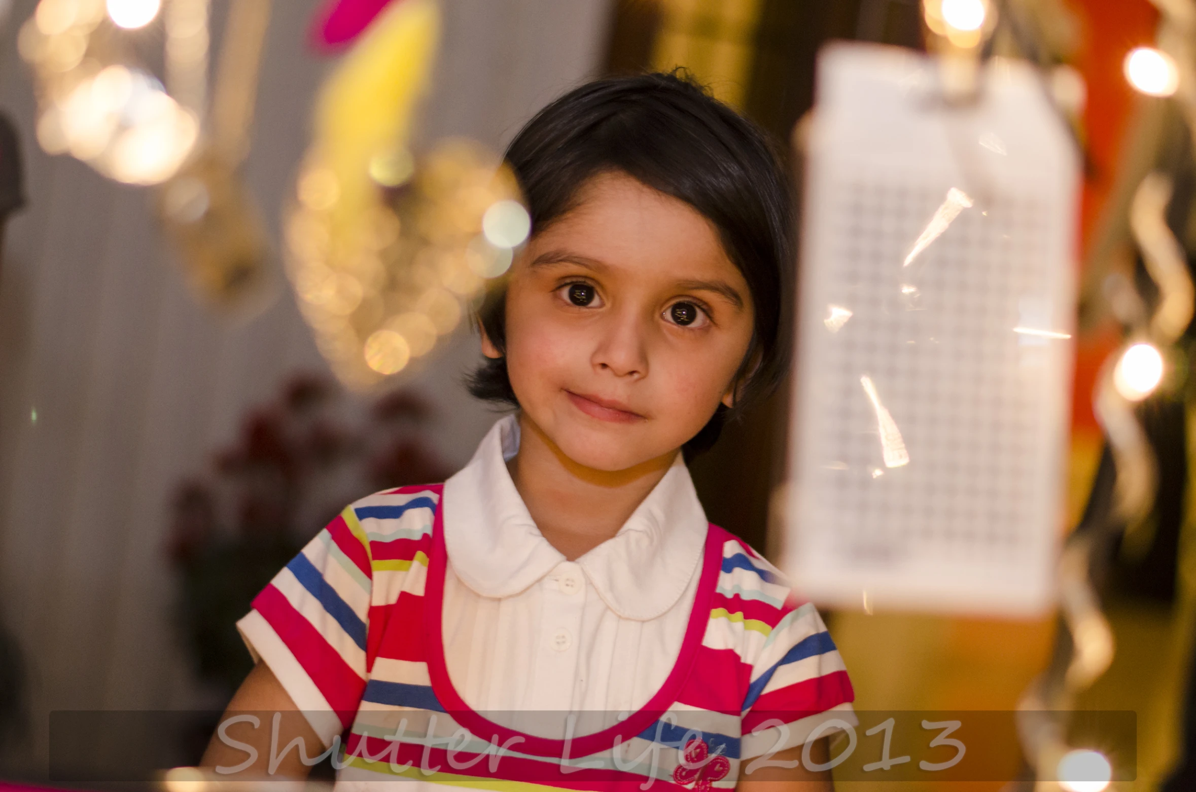 a  is wearing a polo shirt in front of a bunch of candles