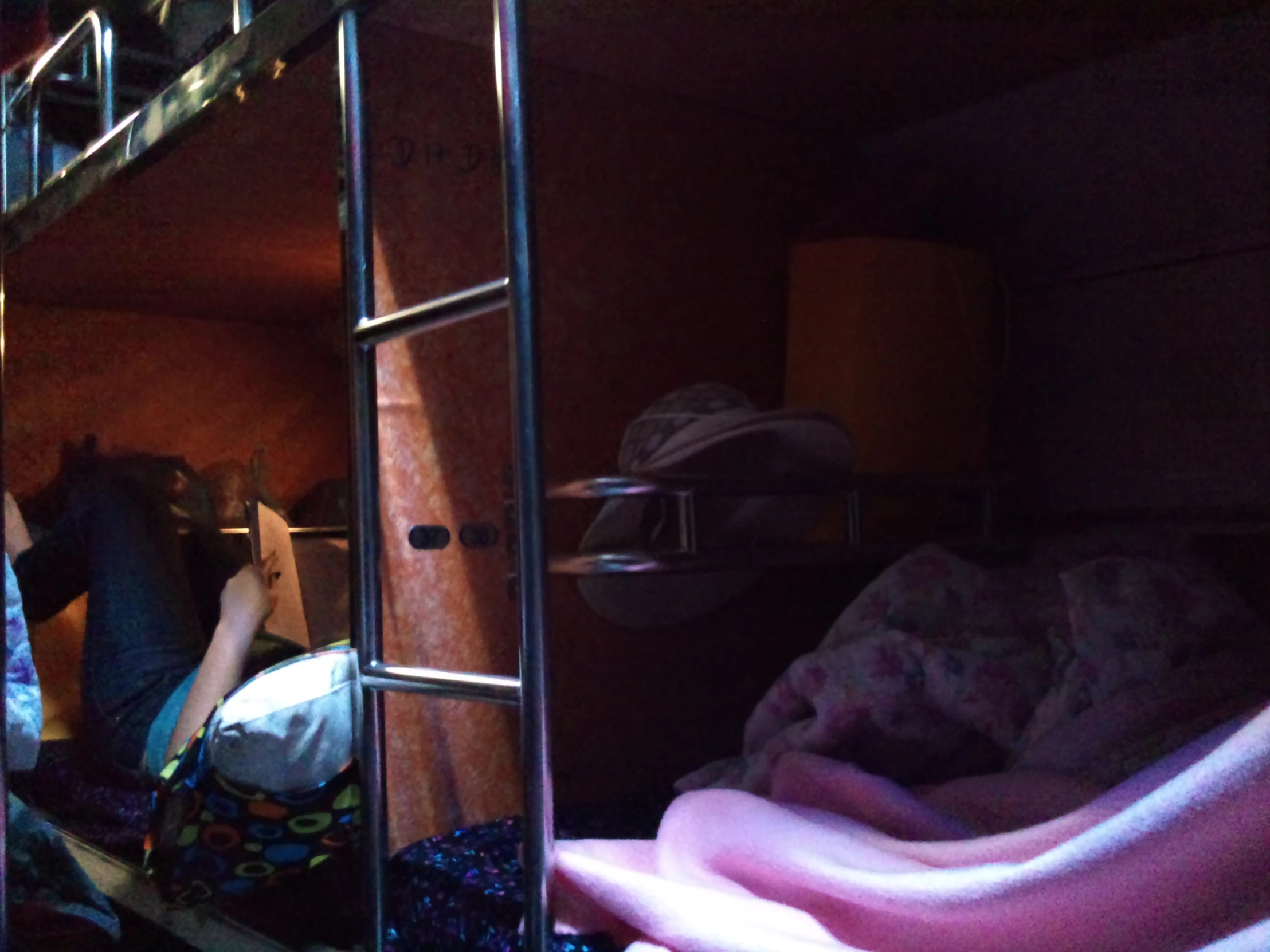 a woman standing in the bottom bunk of a bunk bed