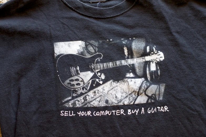 a black shirt with a guitar print on it