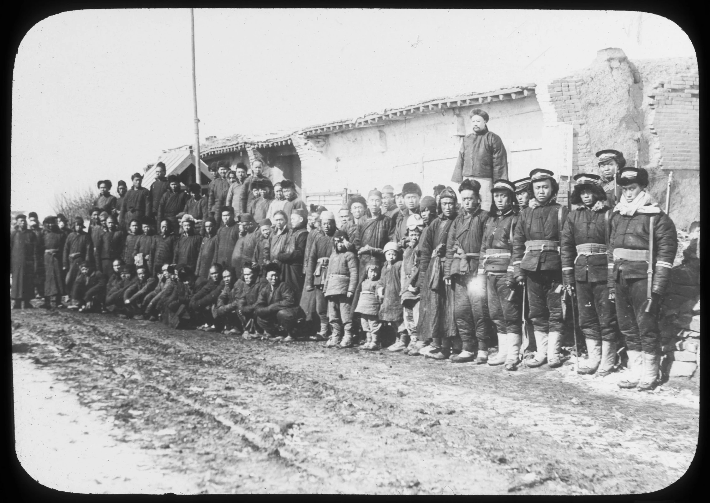 an old black and white po of a group of men standing on side of road