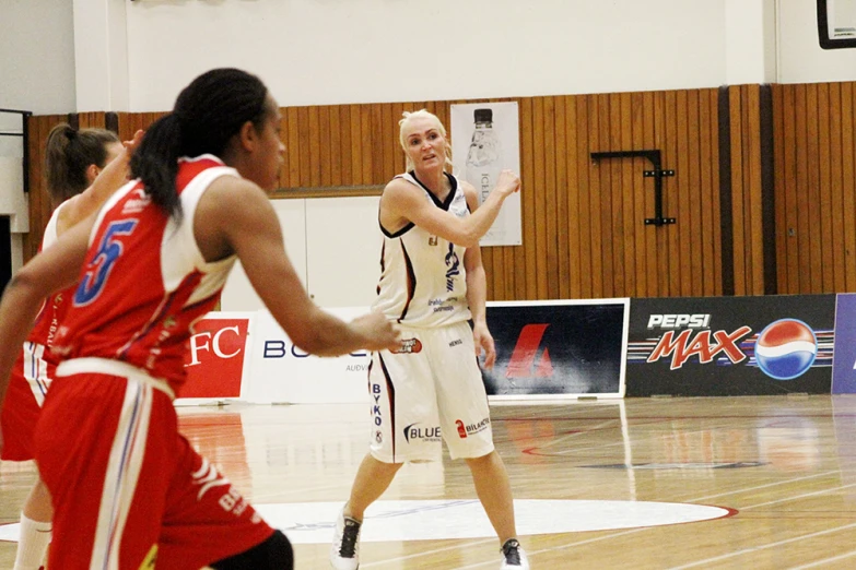 two female basketball players in action on the court