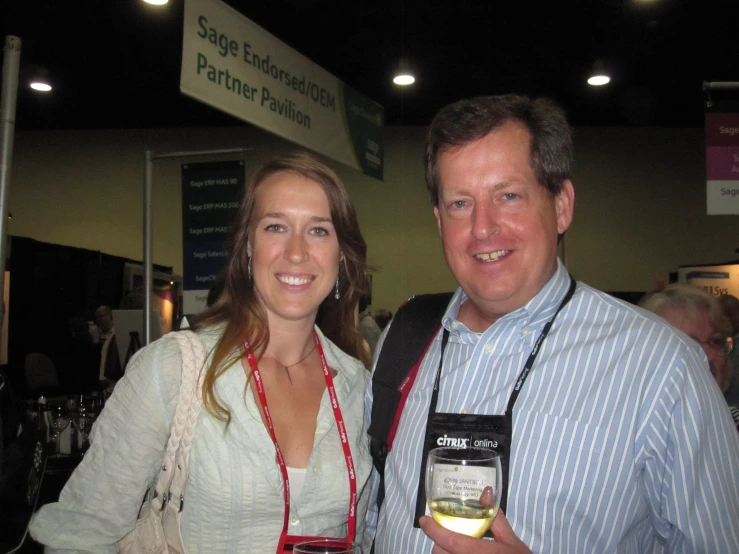 a woman is holding a jar and man is smiling