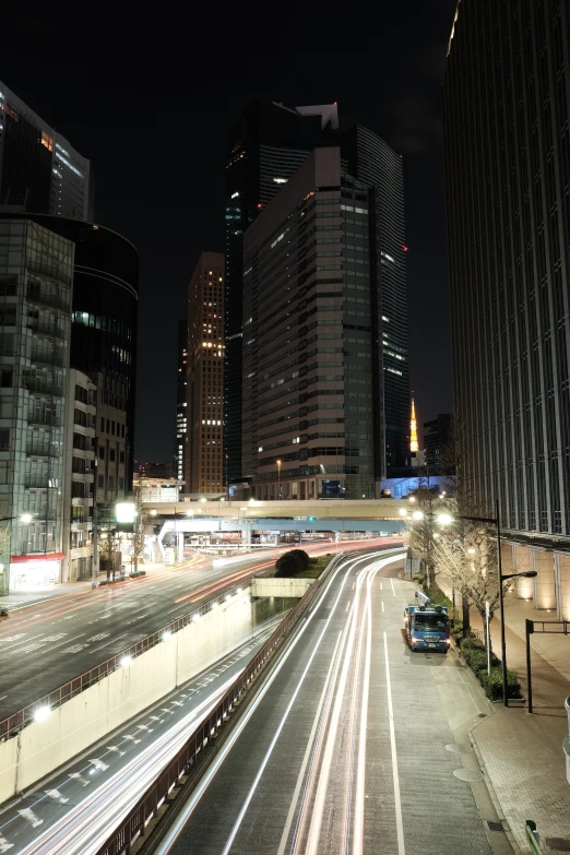 the lights shine as cars drive through an urban area at night