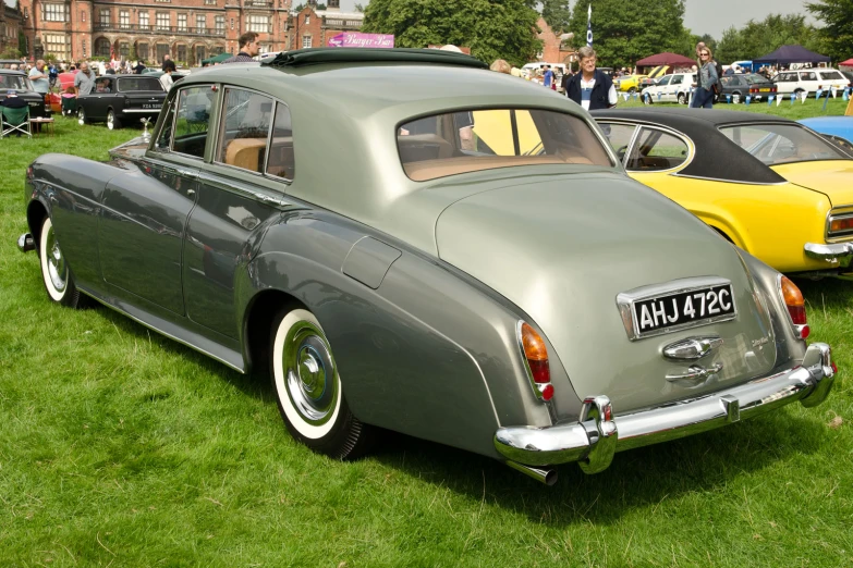 a couple of cars that are parked in the grass