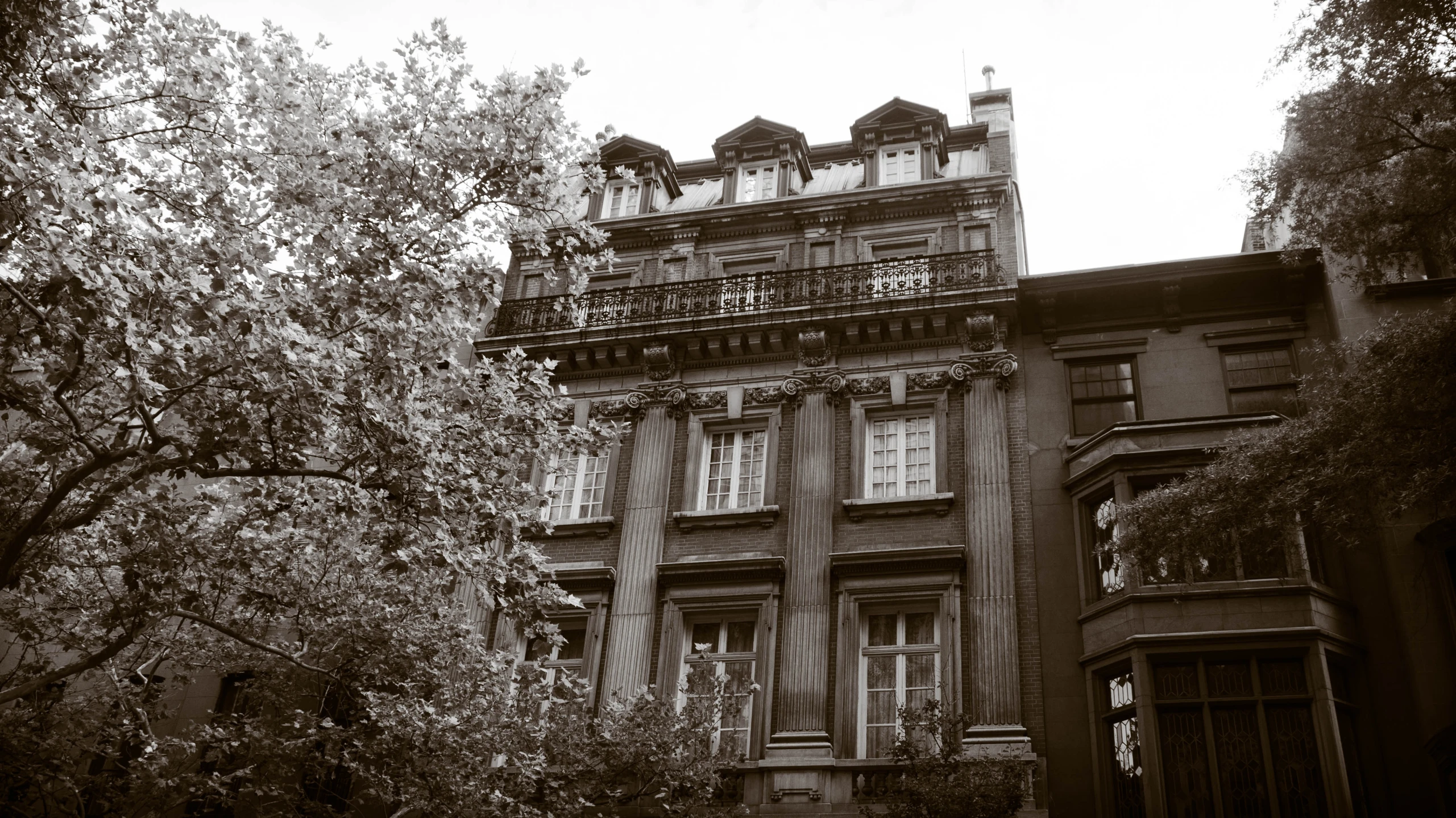 an old building has windows and clocks on the top