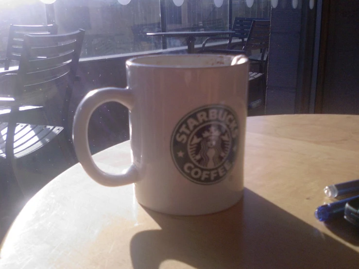 a white starbucks cup is on a table