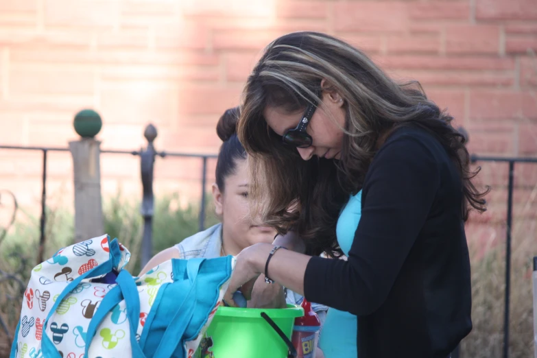 a lady handing someone soing from a bag