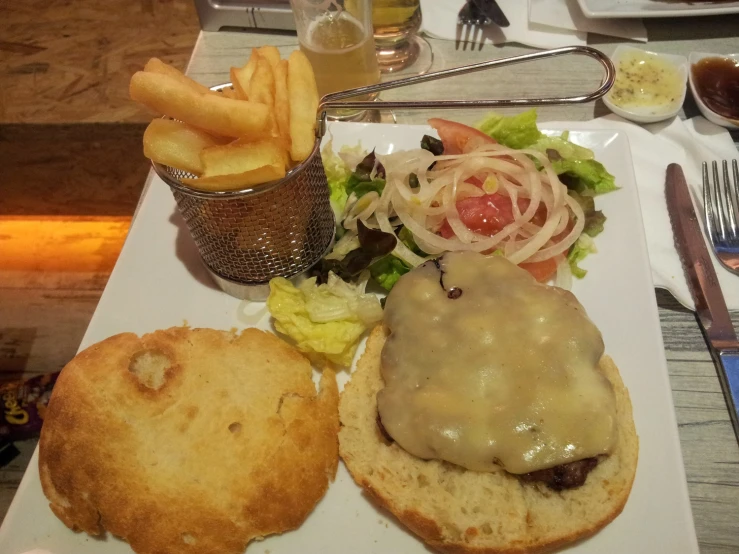 a white plate topped with a hamburger and fries