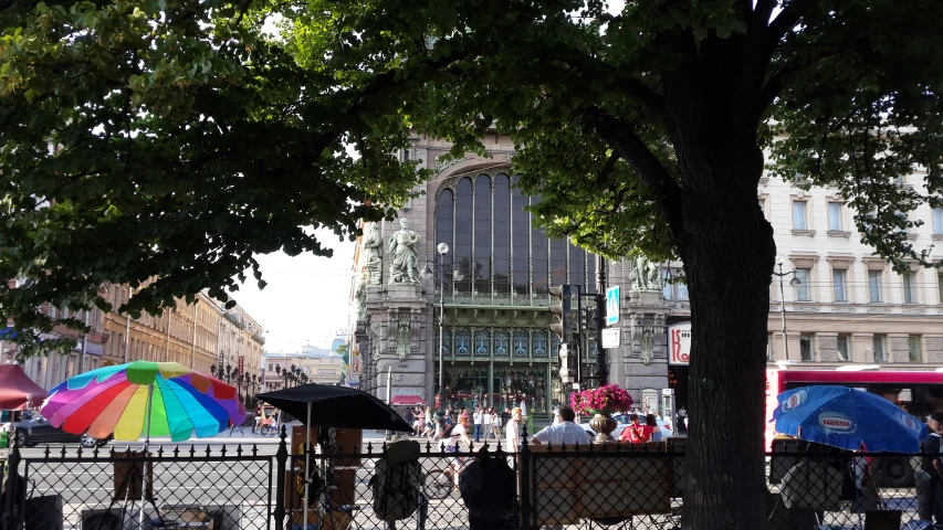 the people are walking around under umbrellas in the city