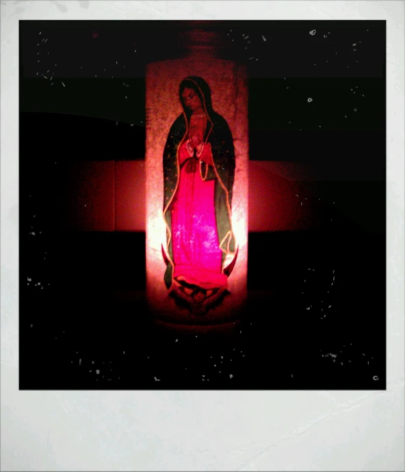 a pograph of the virgin mary of jesus on red paper