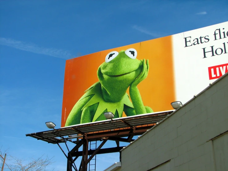 a billboard for a concert with a large po of kermick the frog