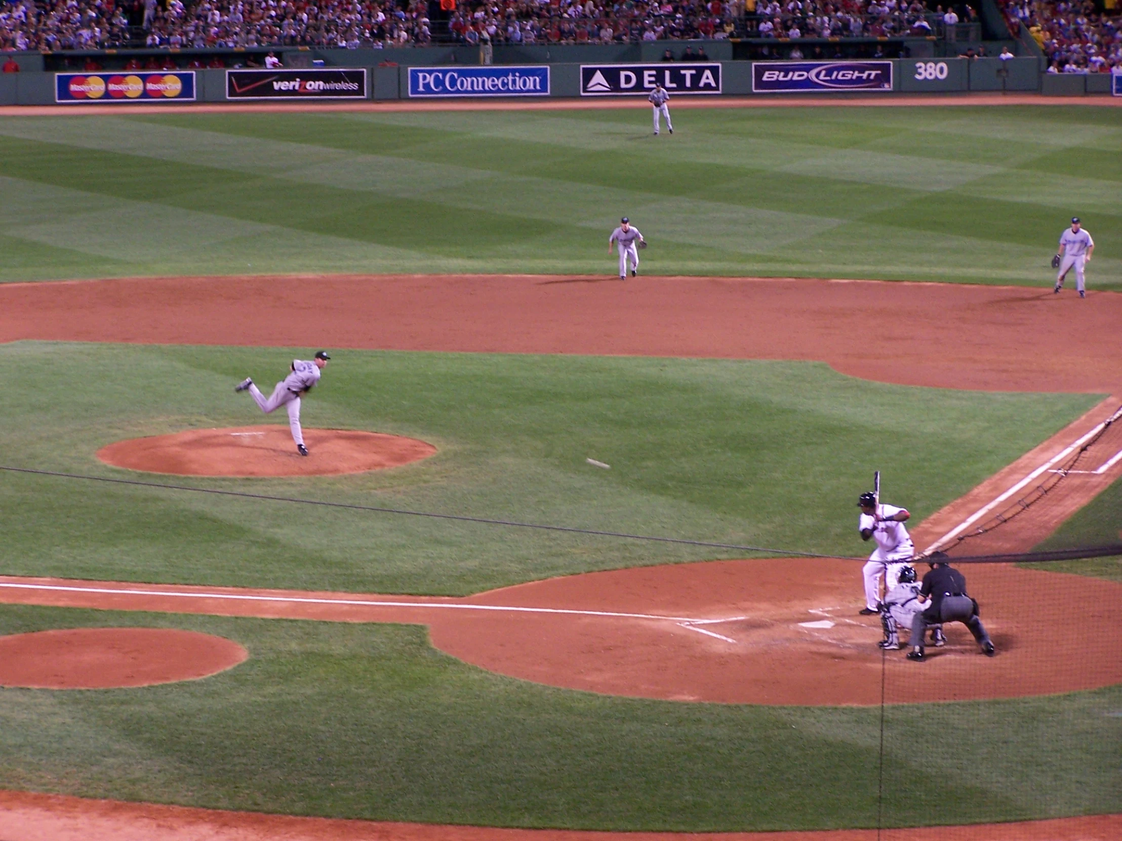 a crowd watches a baseball game being played