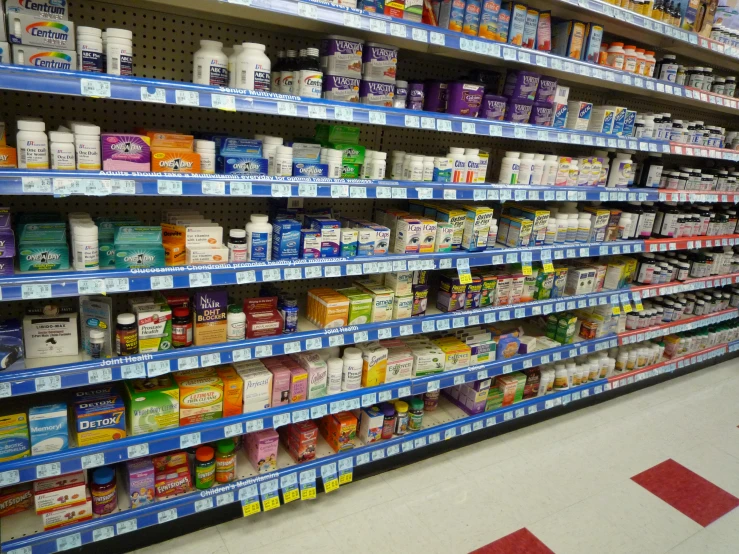 the shelves in a supermarket that contains yogurt and other items