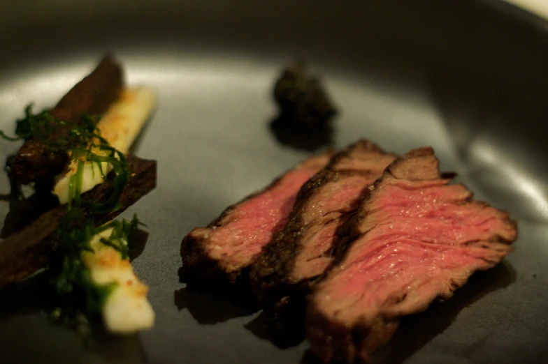 a steak dinner with garnish and some green