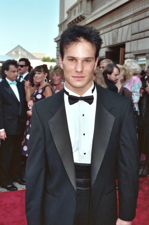 a man in tuxedo with black and white bow tie