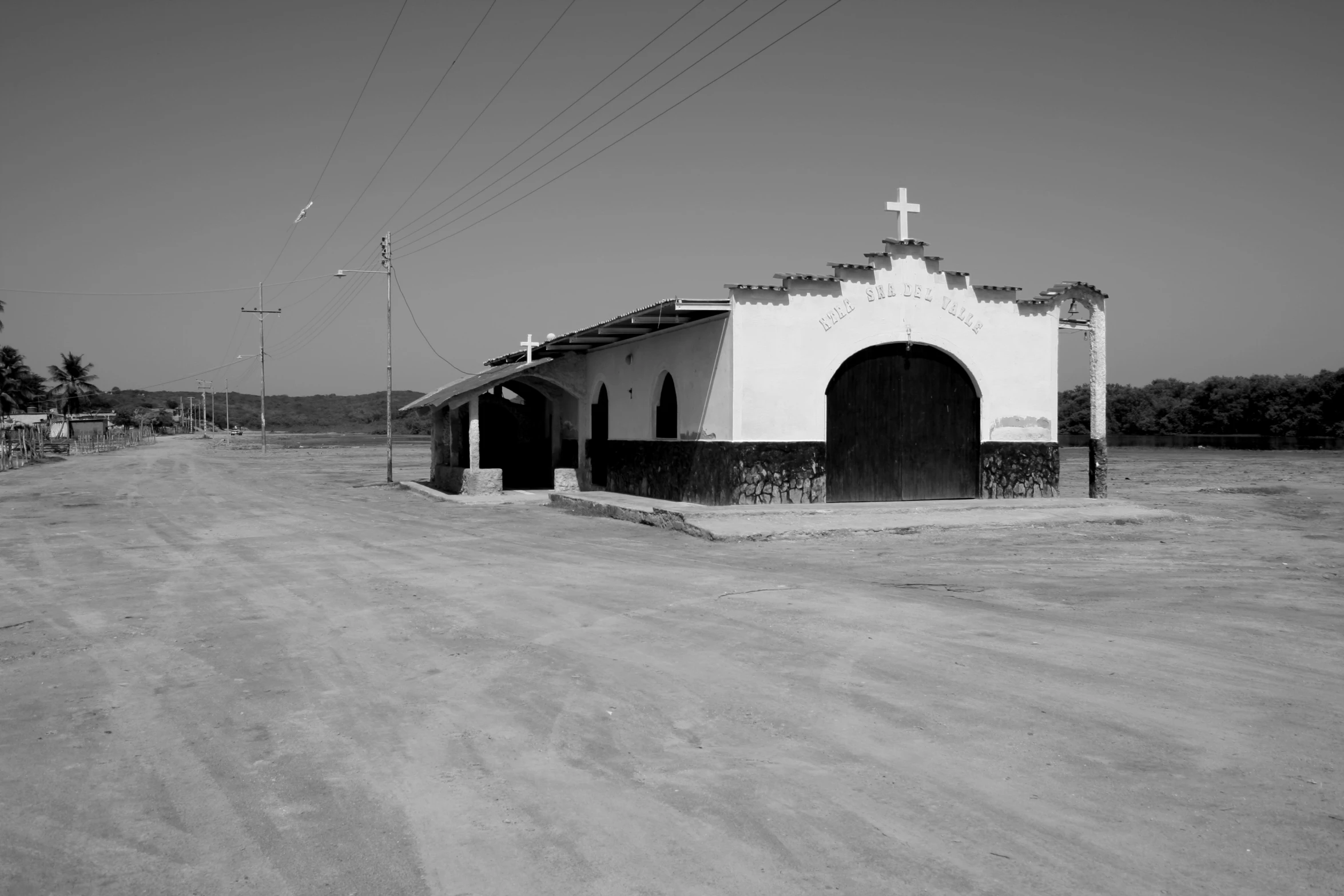 an old church building with a cross on the side of it