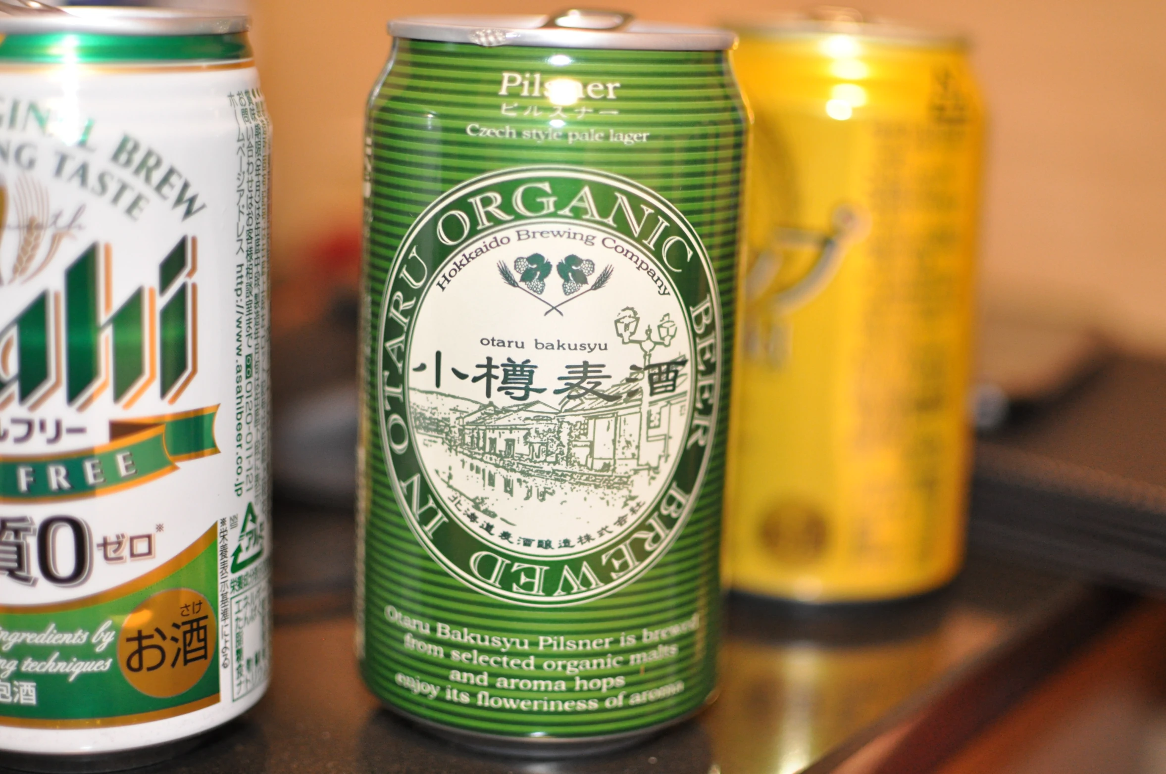 three types of cans of beer are sitting on a table