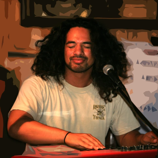 a man that is sitting in front of a microphone