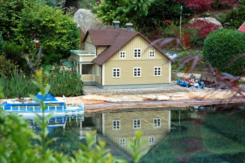 a house on water with several boats and vegetation