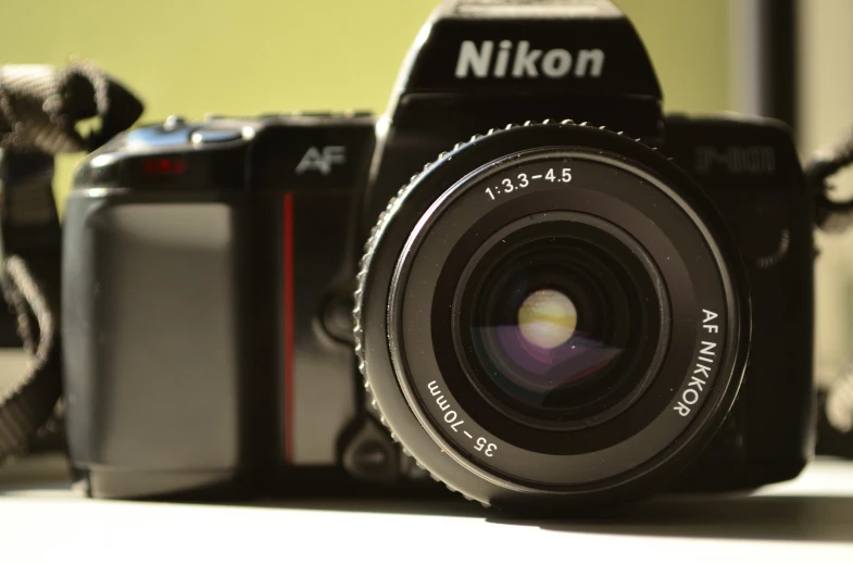 a nikon camera and flash drive, which is equipped with a 16 - 55mm lens