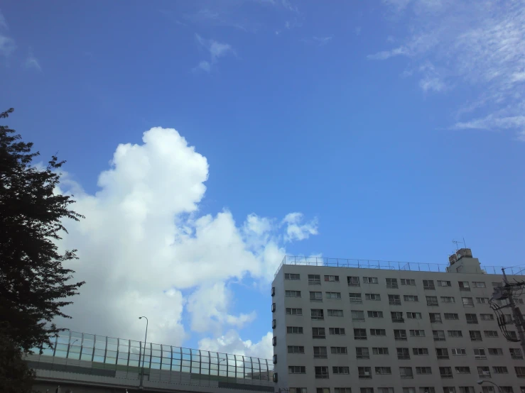 a cloudy blue sky is pictured over some white buildings