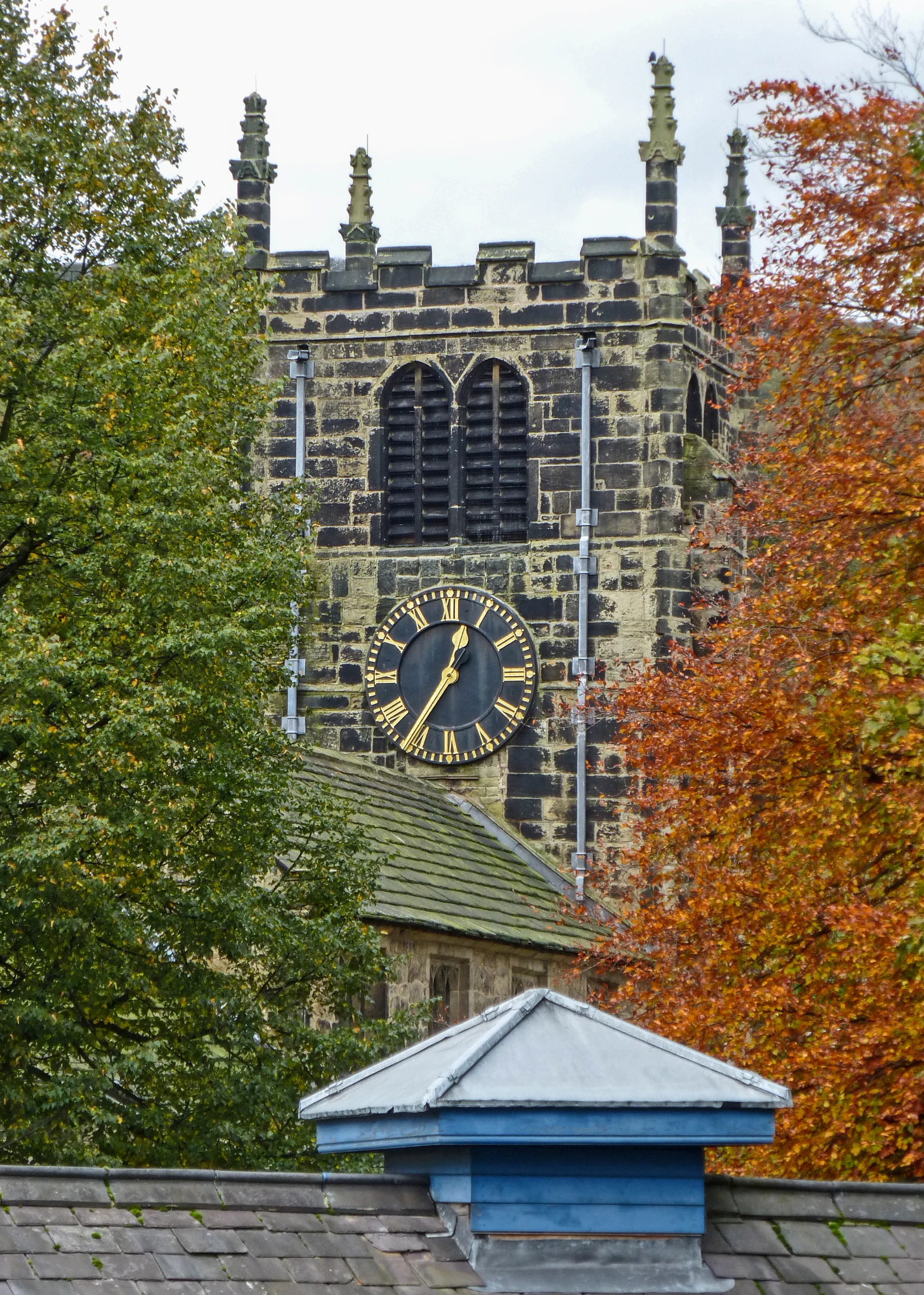 the tower of a building with a clock sits tall