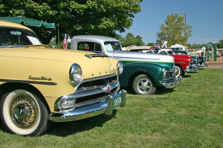 several classic cars are lined up next to each other