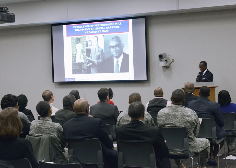 a room full of people at a large seminar