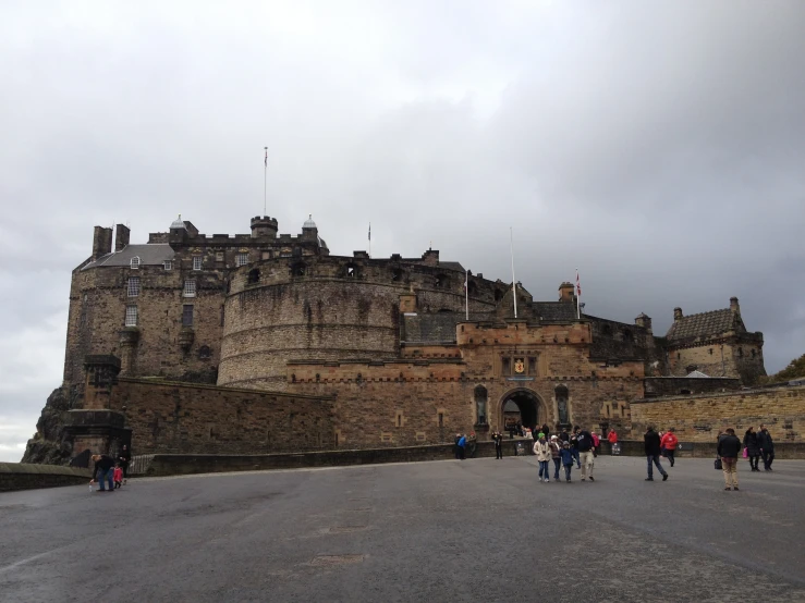 a group of people standing in front of a castle