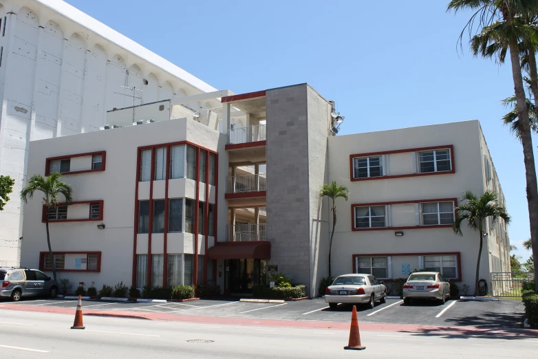 an image of a el building with cars parked in front