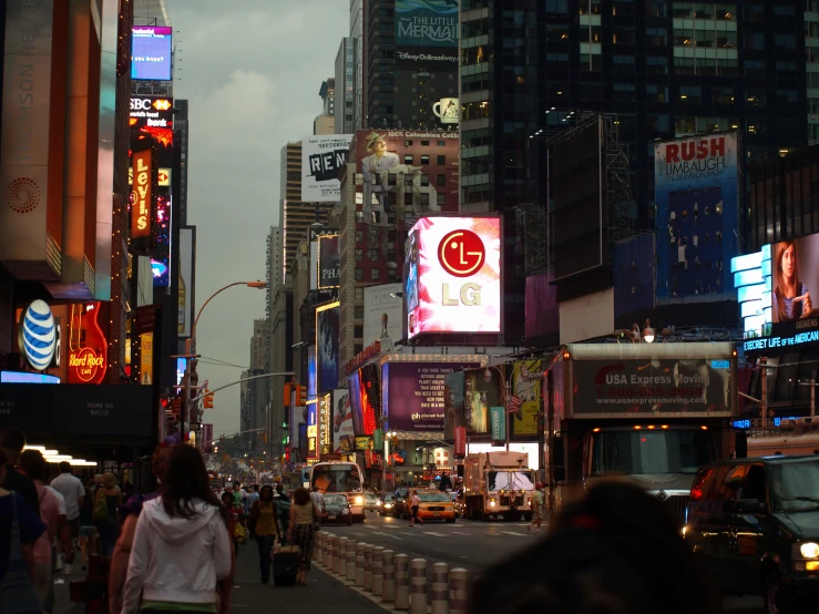 a crowded city street filled with neon lights