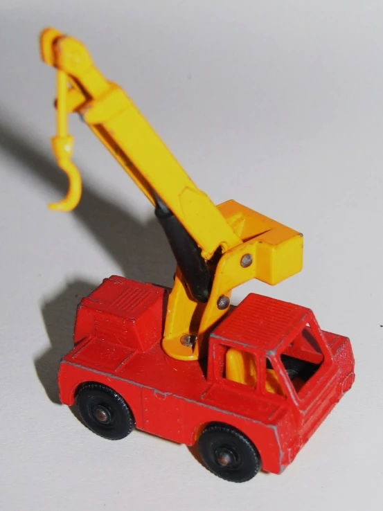 a plastic toy truck with a crane sitting on top