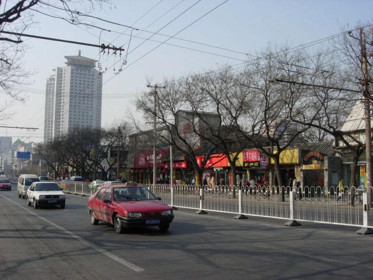 cars and a truck driving down a street