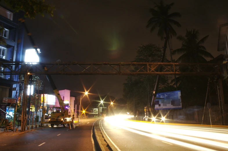 a nighttime s looking down a street at a city intersection