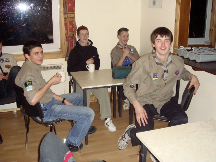 a group of young men in scout uniforms sitting down
