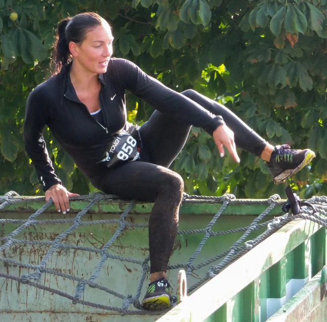 the female skateboarder is sitting on a rusty ledge