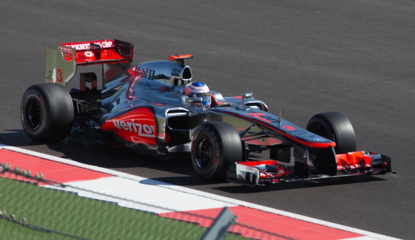 a man driving a race car down a track